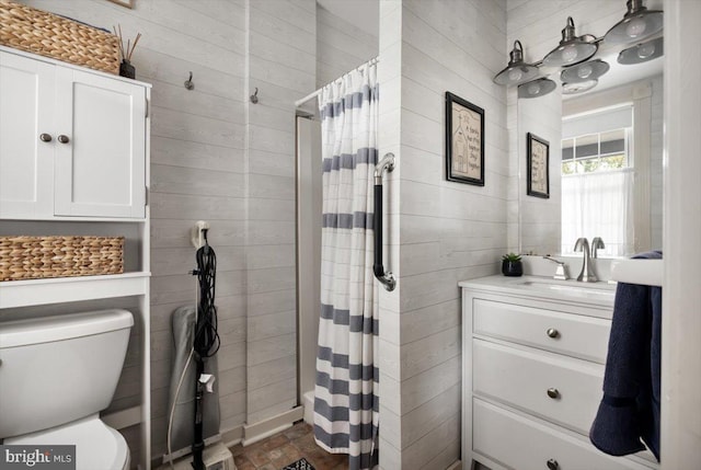 bathroom featuring vanity, toilet, and walk in shower