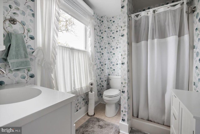 bathroom with a shower with curtain, tile patterned flooring, vanity, and toilet