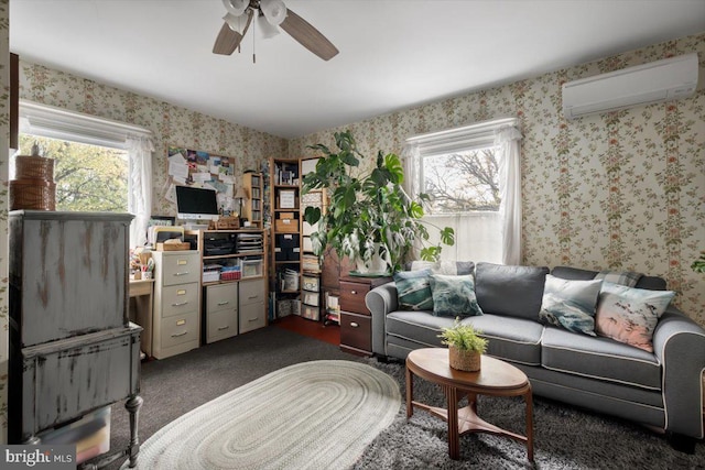 carpeted living room with a wall unit AC, ceiling fan, and a healthy amount of sunlight