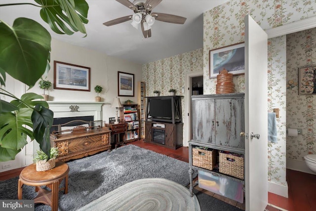 living room featuring ceiling fan and dark wood-type flooring