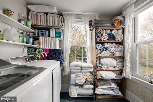 clothes washing area with washing machine and dryer