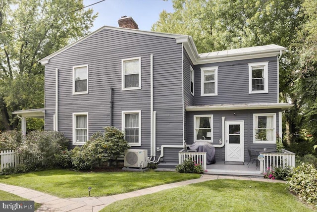 back of house featuring ac unit and a yard