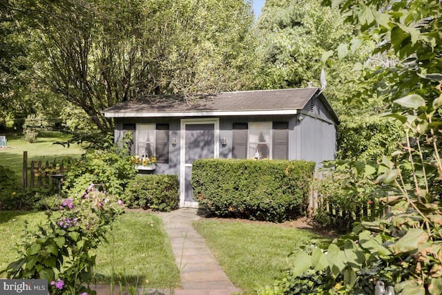 view of outbuilding featuring a lawn