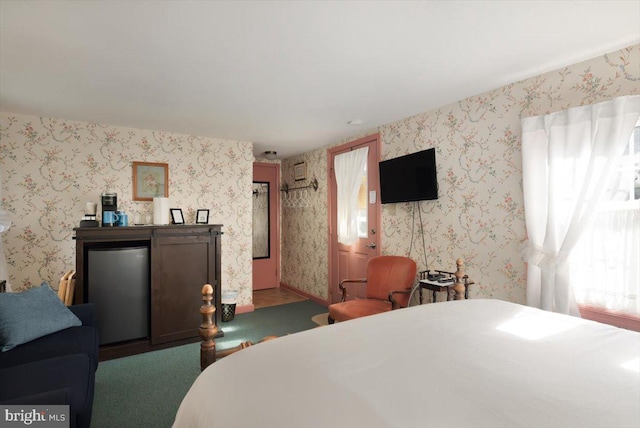 carpeted bedroom featuring refrigerator