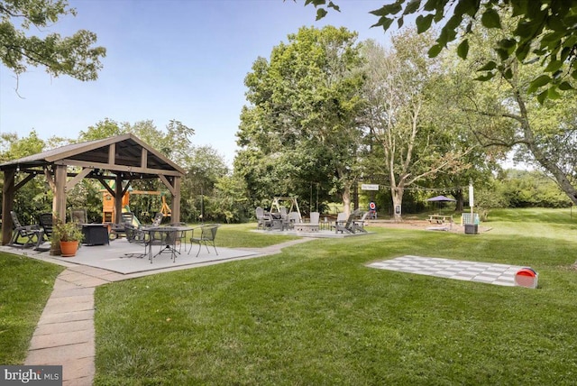 view of community with a gazebo, a yard, and a patio