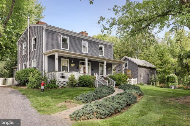 view of front facade with covered porch and a front lawn