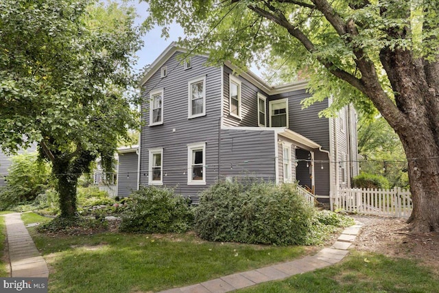 view of side of property with a lawn