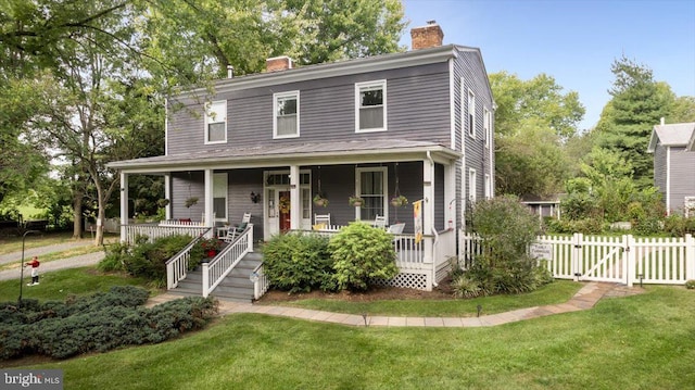 view of front of home with a porch and a front yard