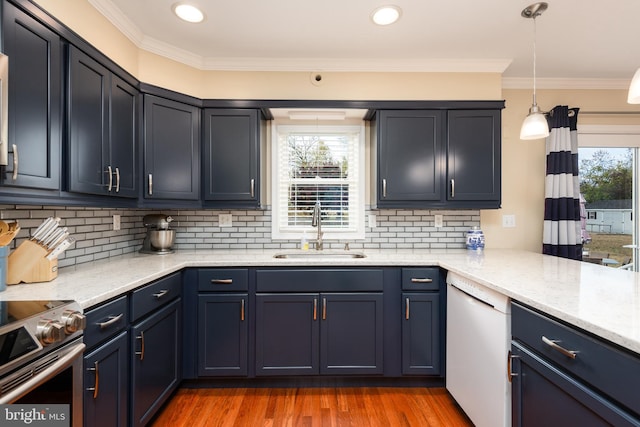 kitchen featuring white dishwasher, hardwood / wood-style floors, sink, and crown molding