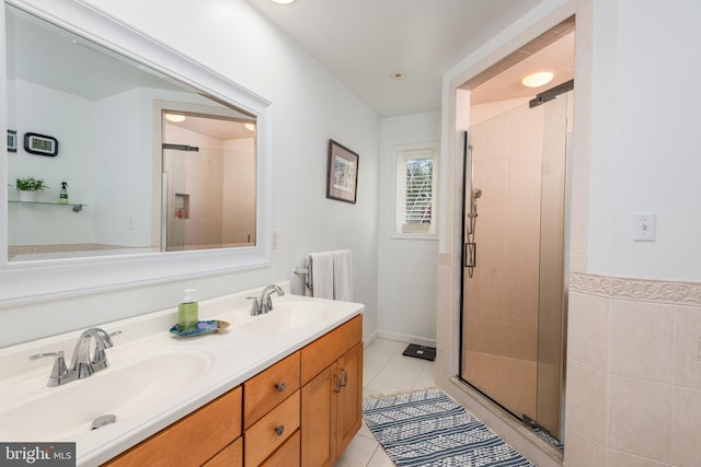 bathroom featuring vanity, tile patterned floors, and an enclosed shower