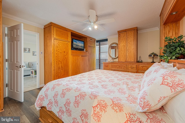 bedroom with crown molding, a textured ceiling, dark hardwood / wood-style floors, and ceiling fan