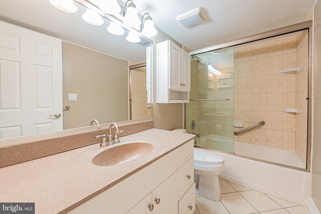 full bathroom featuring toilet, vanity, tile patterned flooring, and shower / bath combination with glass door