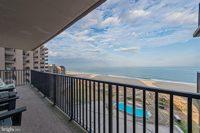 balcony featuring a water view and a view of the beach