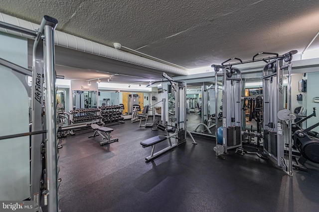 gym with a textured ceiling