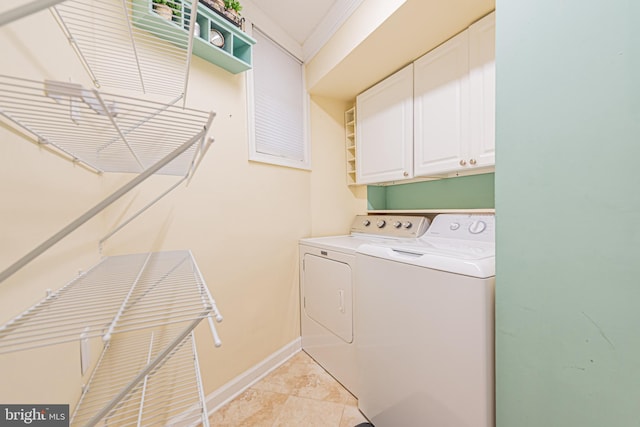 laundry room with cabinets and washing machine and clothes dryer