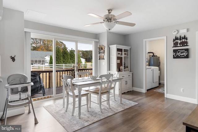 dining space with washer and clothes dryer, hardwood / wood-style floors, and ceiling fan