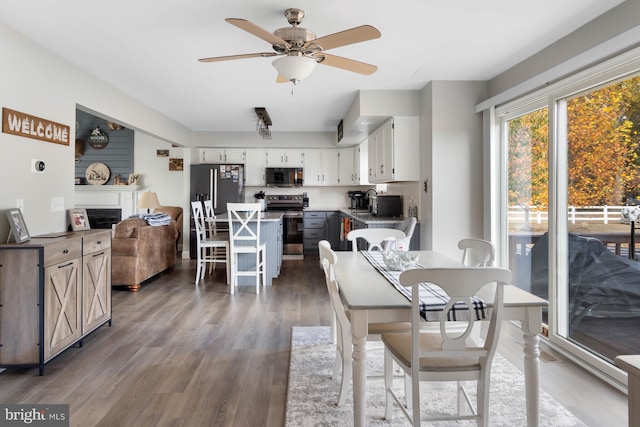 dining space featuring dark hardwood / wood-style floors and ceiling fan