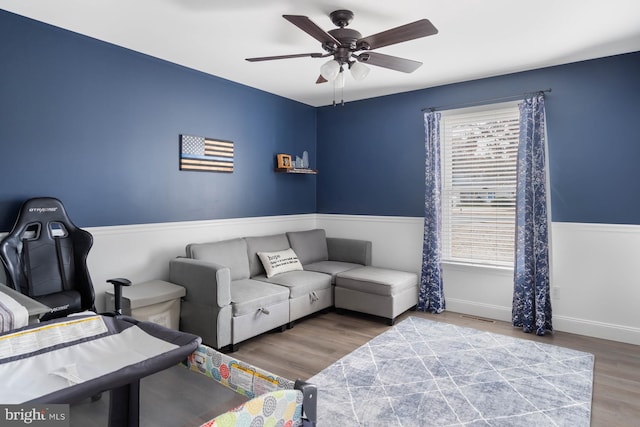 living room featuring ceiling fan and wood-type flooring