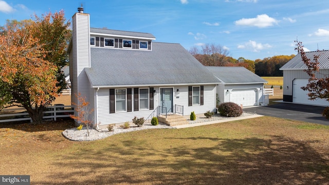 view of front of home with a front yard and a garage