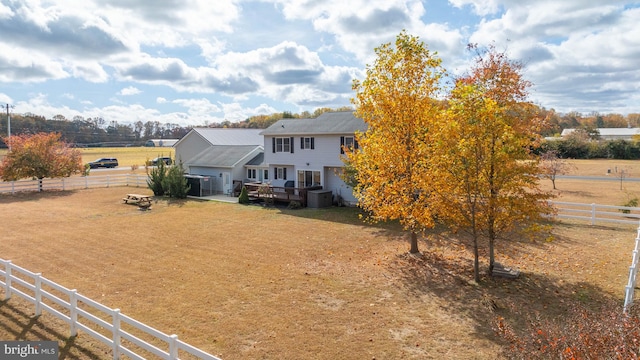 rear view of house featuring a rural view and a wooden deck