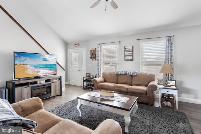 living room featuring light hardwood / wood-style flooring, ceiling fan, and vaulted ceiling