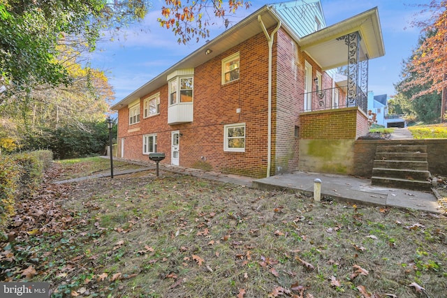 view of side of home featuring a patio area