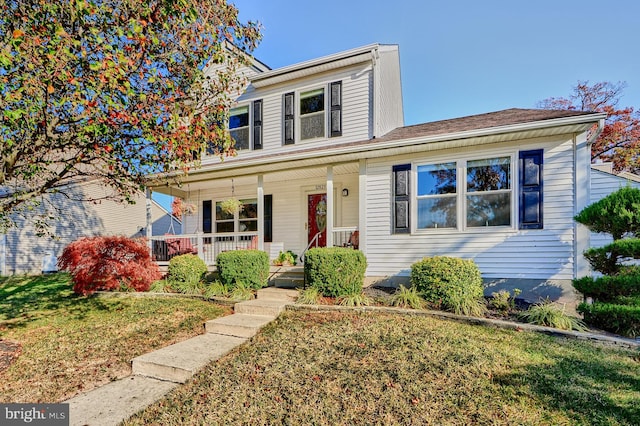 view of front of home with a porch and a front lawn