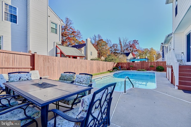 view of swimming pool featuring a patio