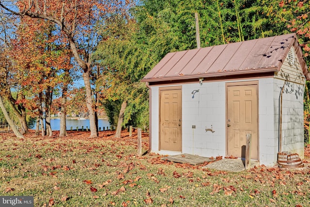 view of outbuilding with a water view