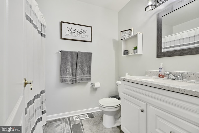 bathroom featuring hardwood / wood-style floors, vanity, and toilet