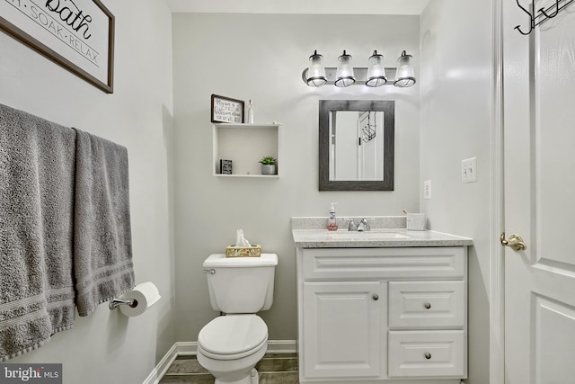 bathroom featuring tile patterned flooring, vanity, and toilet