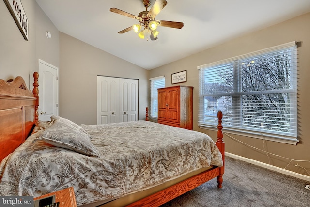 bedroom with carpet flooring, ceiling fan, a closet, and vaulted ceiling