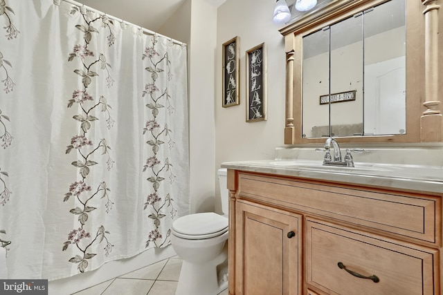 bathroom featuring tile patterned flooring, vanity, and toilet