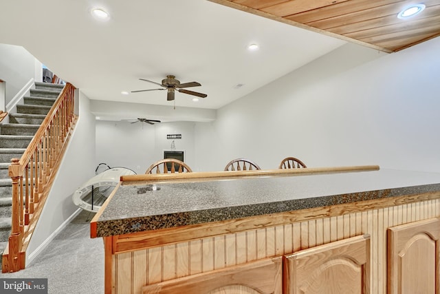 kitchen with carpet flooring, light brown cabinetry, ceiling fan, and wood ceiling