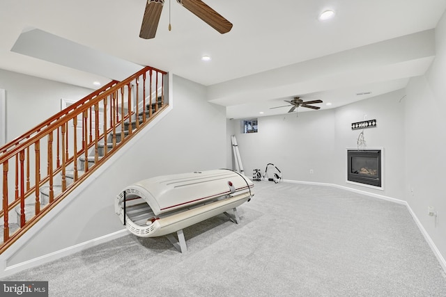 interior space with carpet flooring and ceiling fan