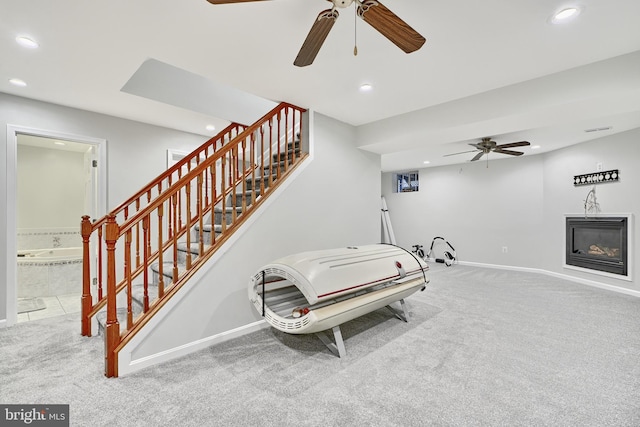 interior space with carpet and ceiling fan