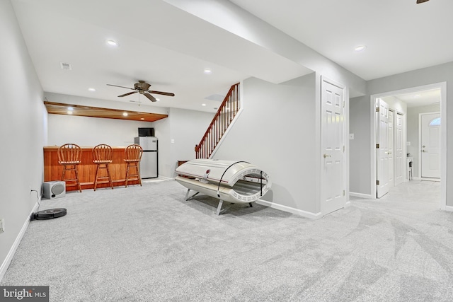 sitting room with light colored carpet and ceiling fan