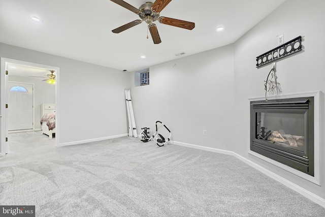 carpeted living room featuring ceiling fan