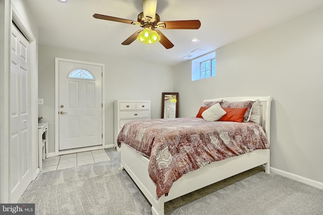 carpeted bedroom with ceiling fan and a closet