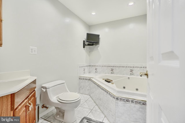 bathroom featuring tile patterned flooring, vanity, a relaxing tiled tub, and toilet