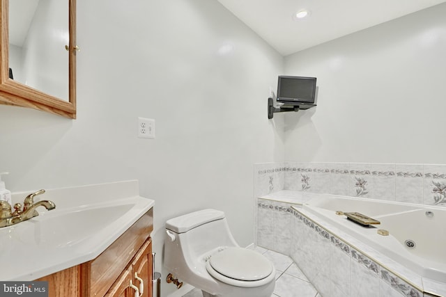 bathroom featuring tile patterned flooring, vanity, toilet, and tiled bath