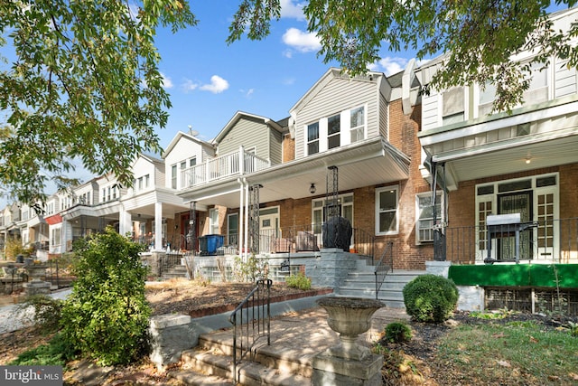 back of property featuring covered porch