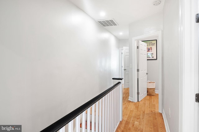 corridor with light hardwood / wood-style floors