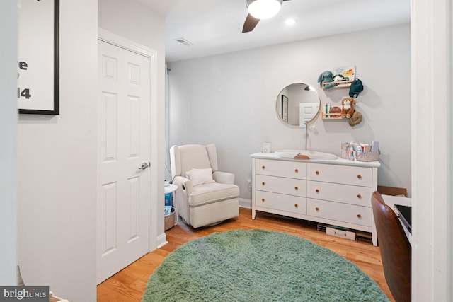 sitting room featuring ceiling fan and light hardwood / wood-style flooring