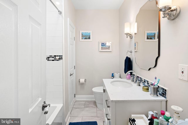 full bathroom featuring vanity, tiled shower / bath combo, and toilet