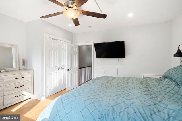 bedroom with ceiling fan and light hardwood / wood-style flooring