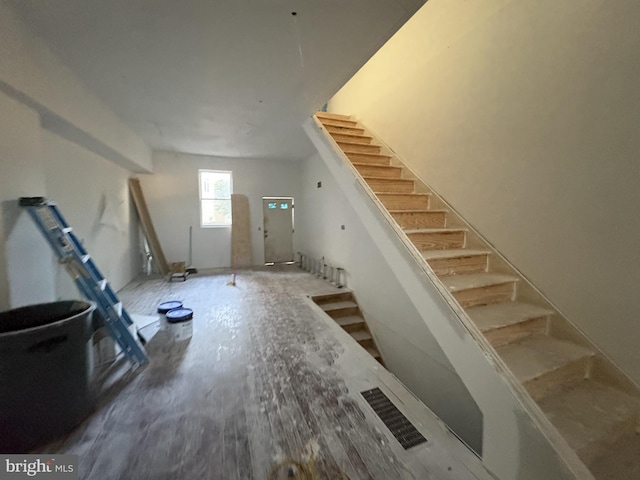 staircase with hardwood / wood-style floors