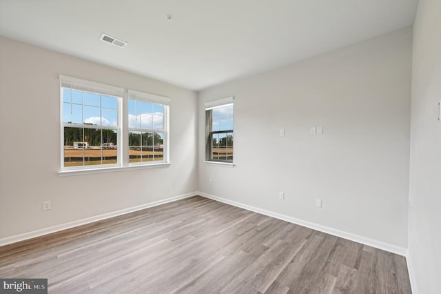 spare room featuring light hardwood / wood-style floors