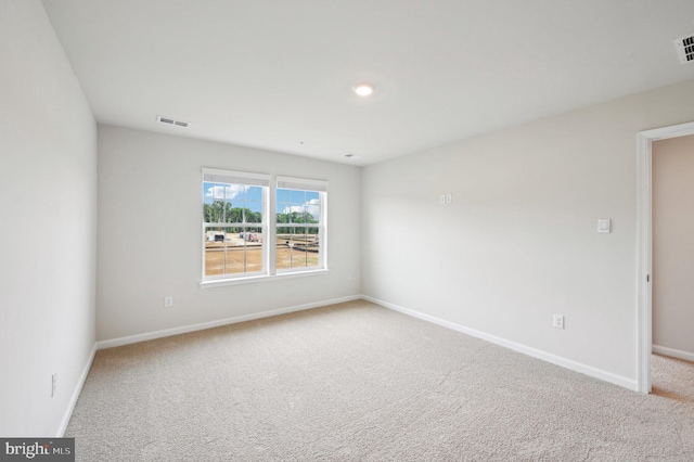 unfurnished room featuring carpet flooring