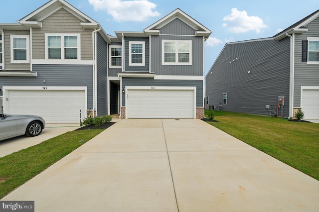 view of front of property with a garage and a front lawn